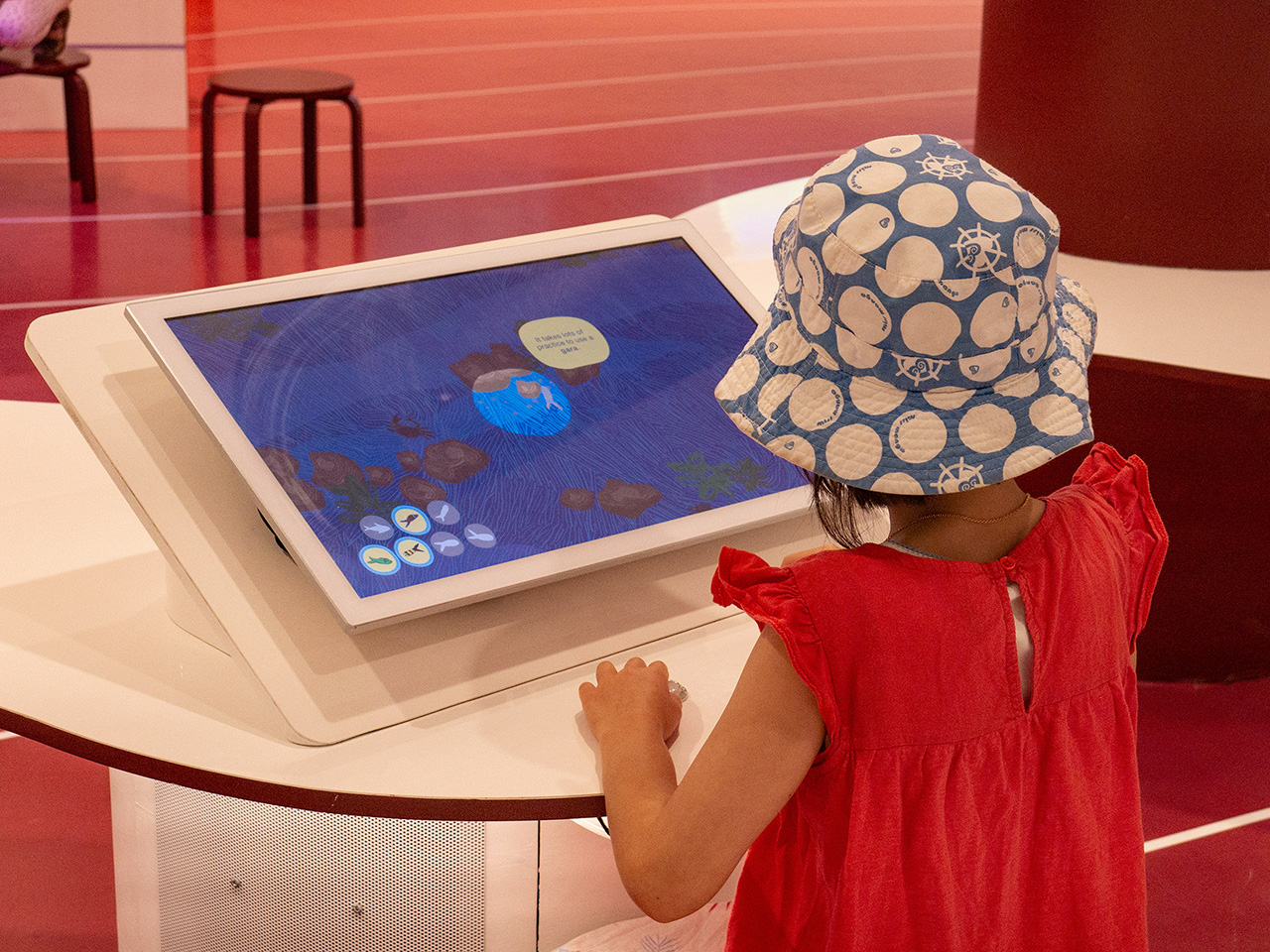 A girl playing the fish level from A Walk in the Bush.