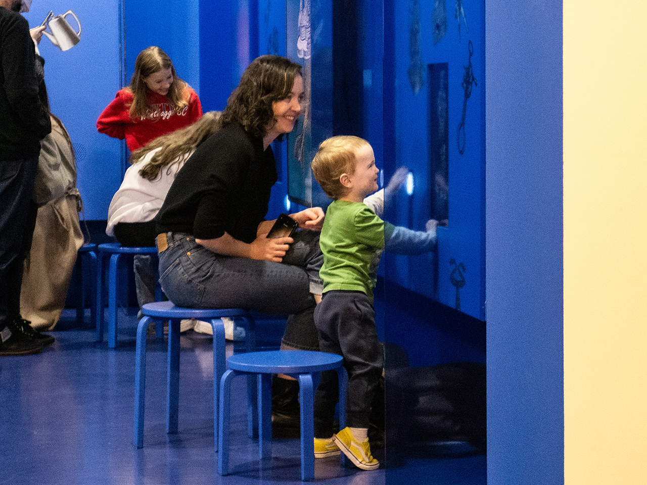 A mother and son smiling while playing Make a Creature.