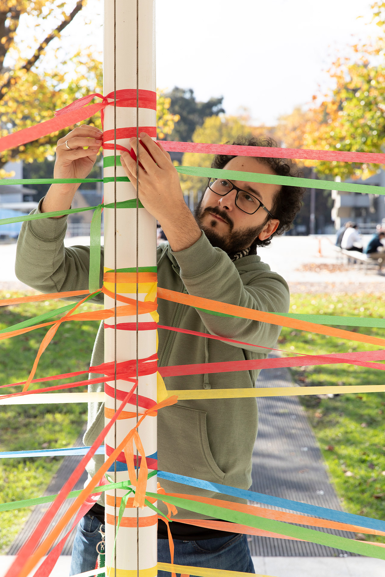 Artist Chad Toprak adding a thread to the Transient Threads installation.