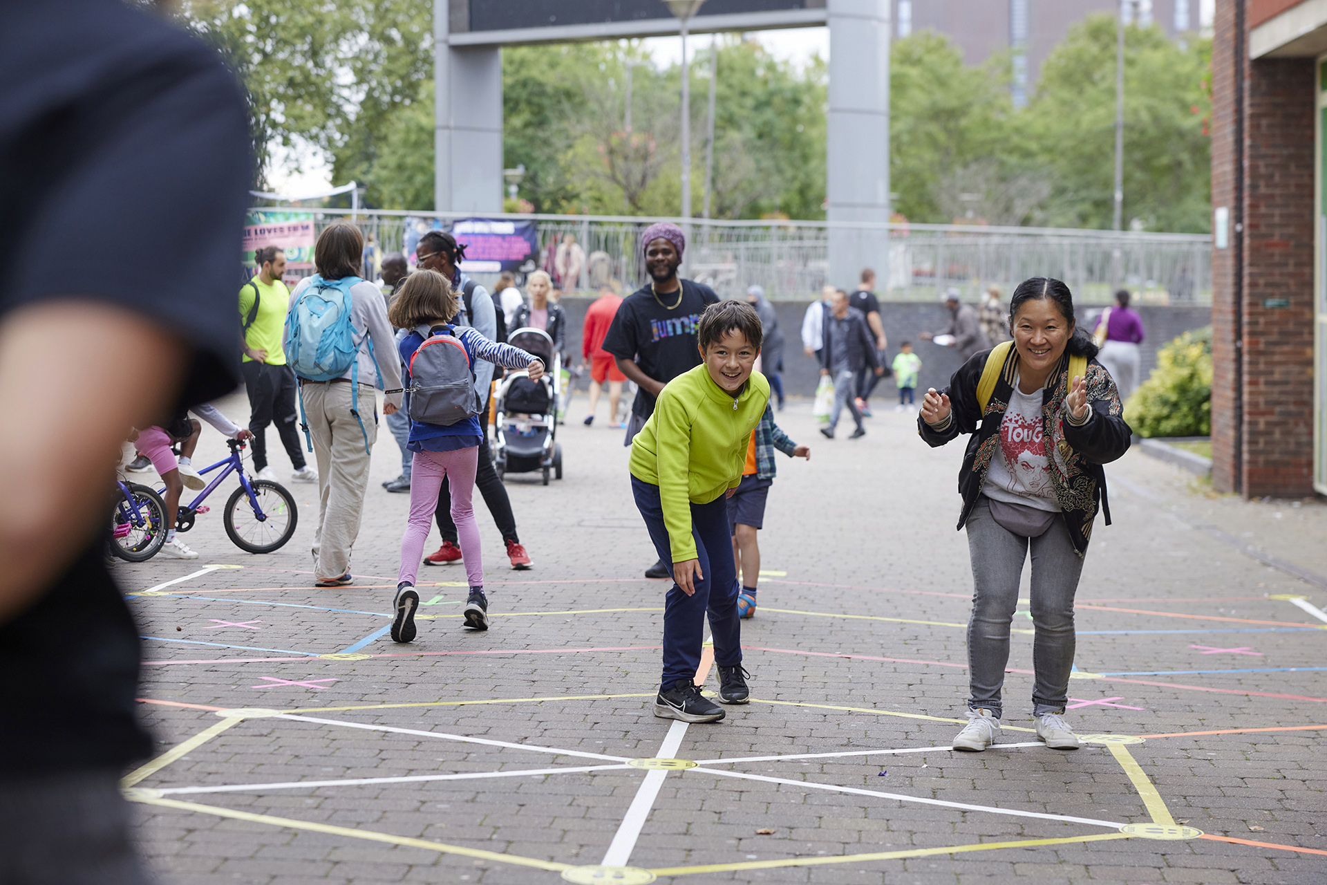 Mother and child ready to make their move during a game of Street Tape Games.