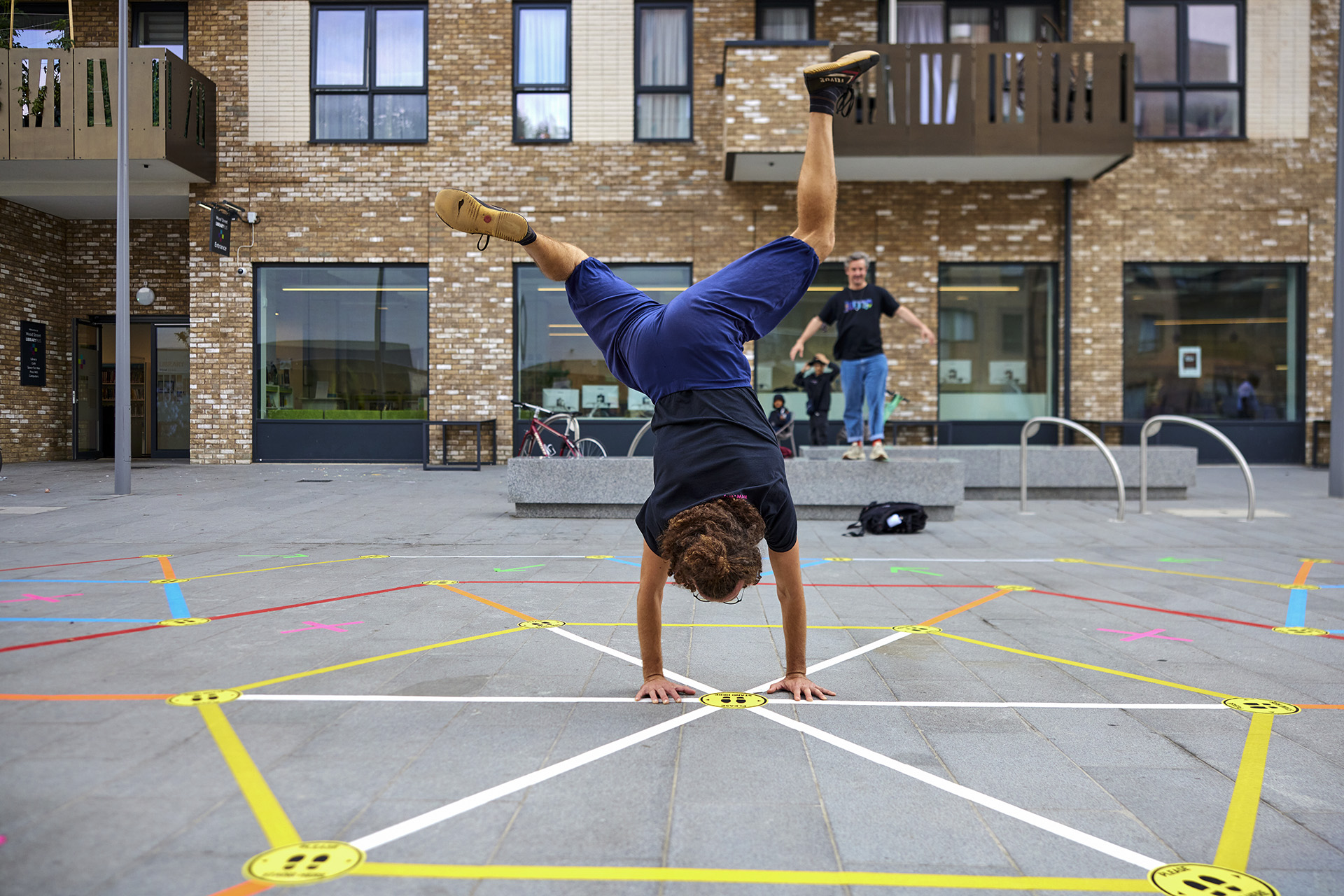 A player doing a cartwheel on the Street Tape Games installation.