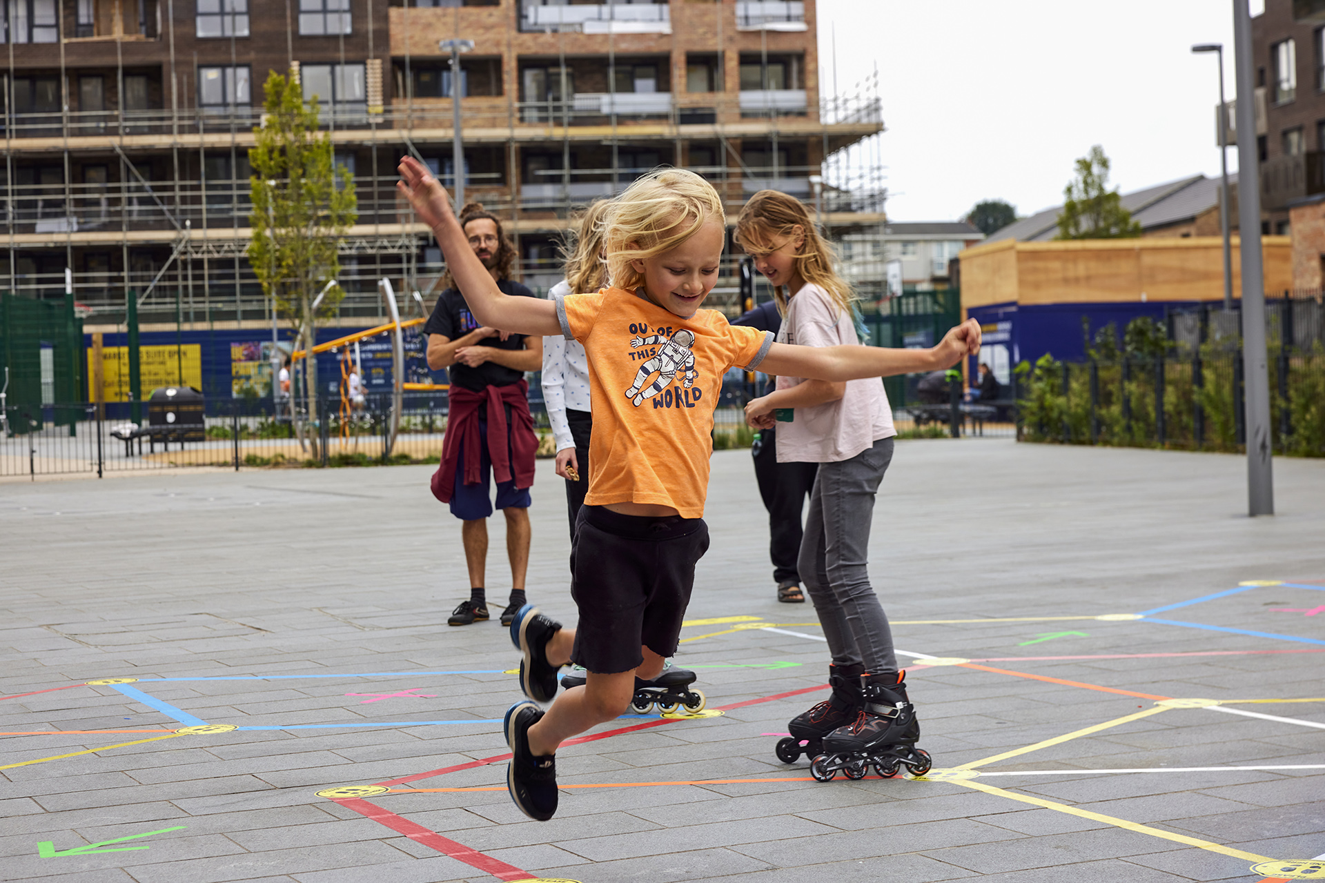 A kid jumping along a tape of Street Tape Games in Waltham Forest, London.