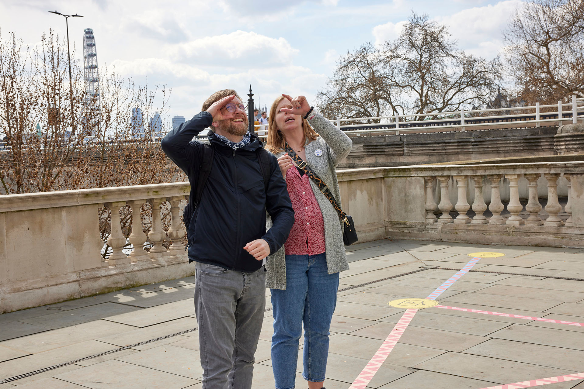 Two players looking up and tracing windows of their finger as part of a mini-game in the Rainbow Paths installation at Now Play This festival.