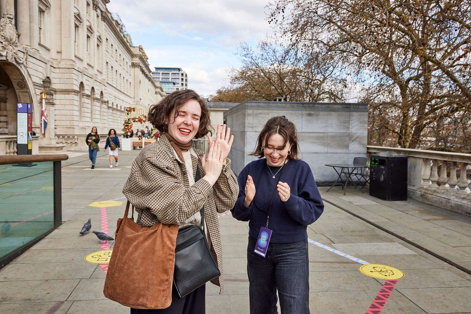 Two players clapping together as part of the Rainbow Paths installation at Now Play This festival.