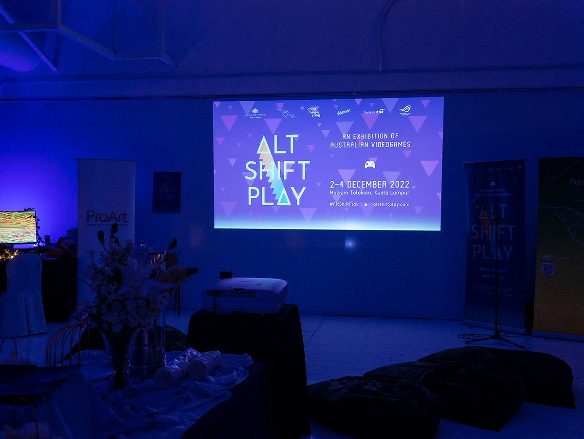 Projector showing the Alt-Shift-Play details on a wall.