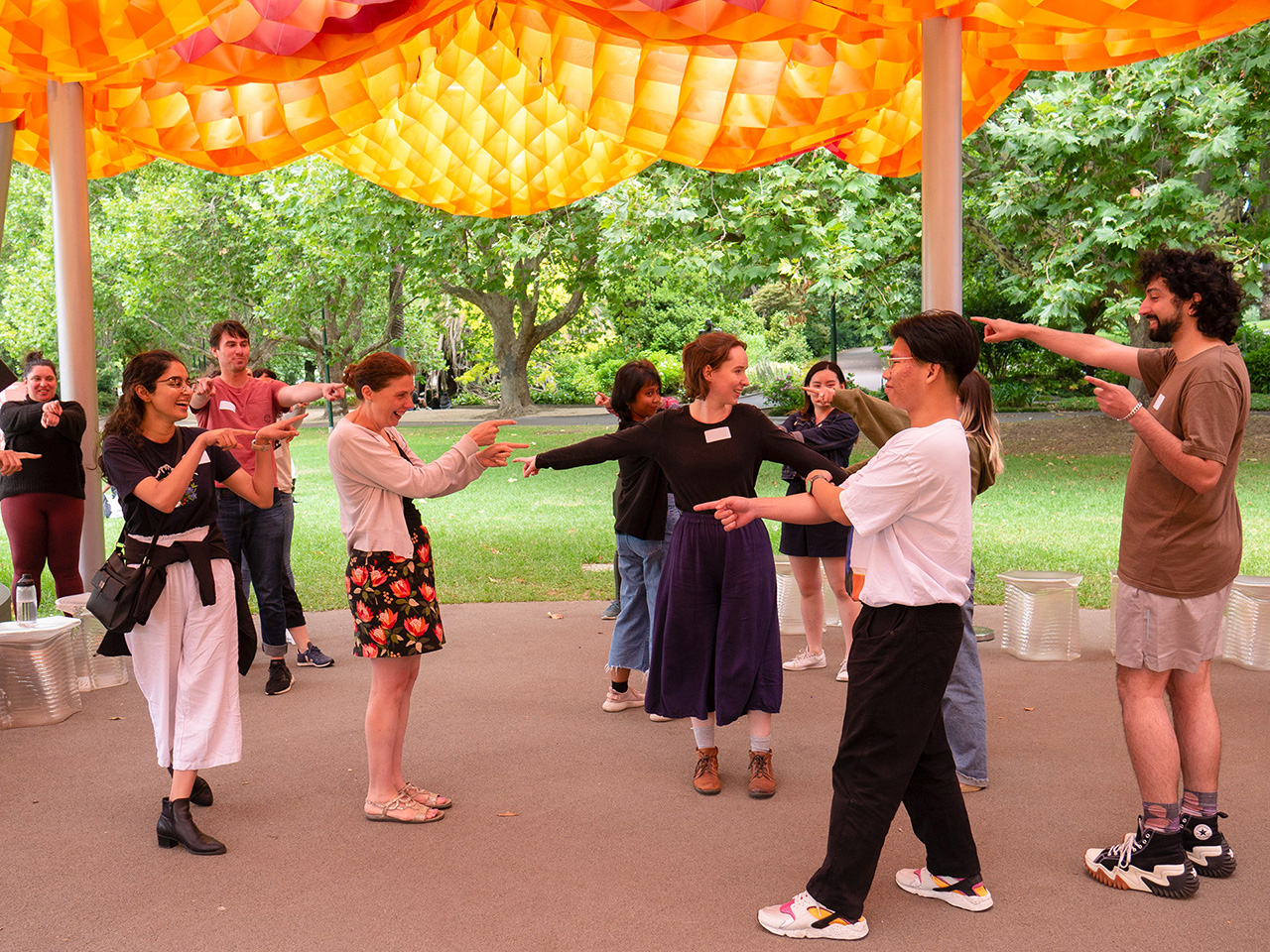 Participants pointing at each other during a game at MPavilion.