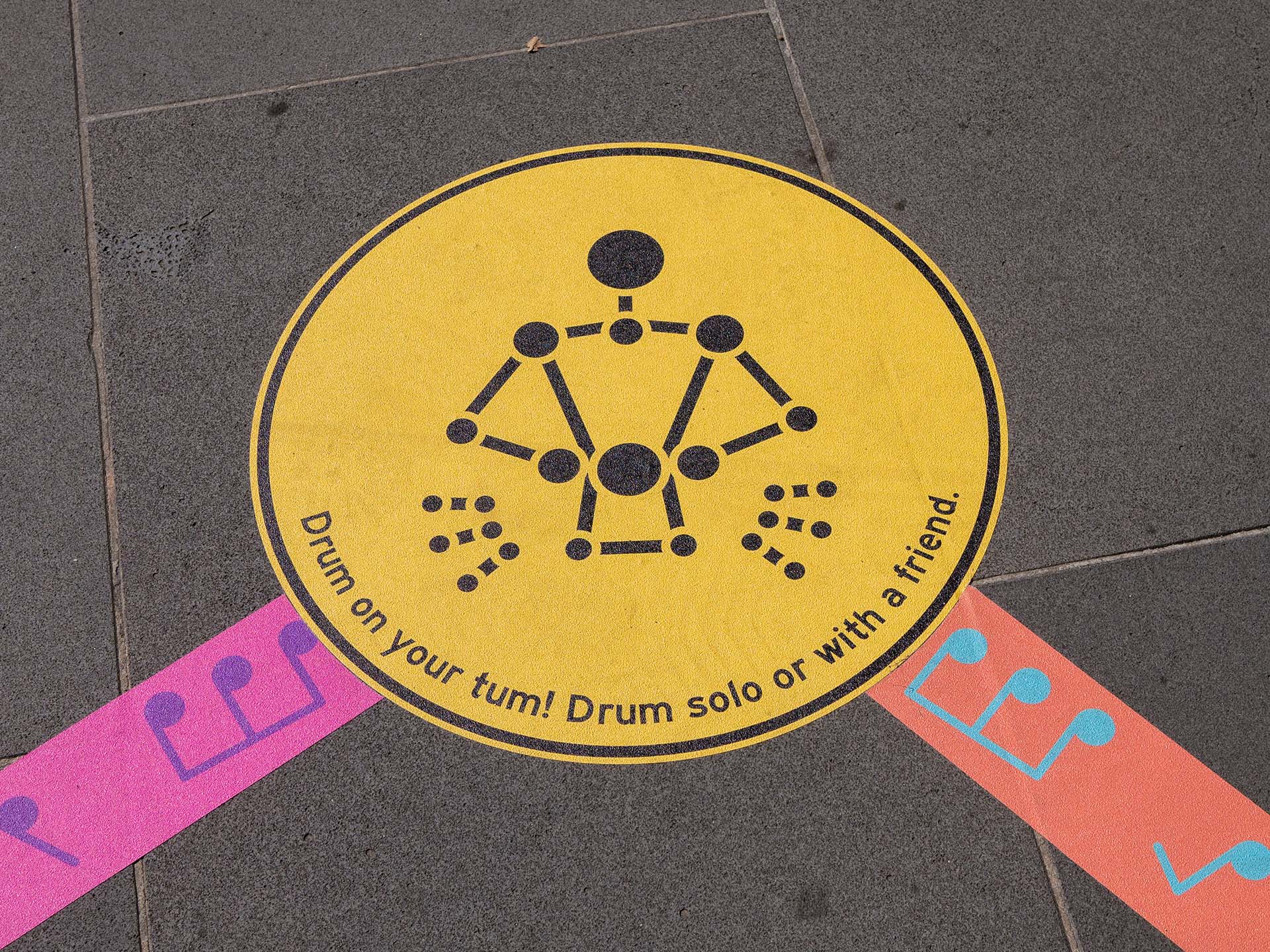 Close-up of the 'Drum your tum' mini-game from the Rainbow Paths installation at Melbourne Recital Centre.