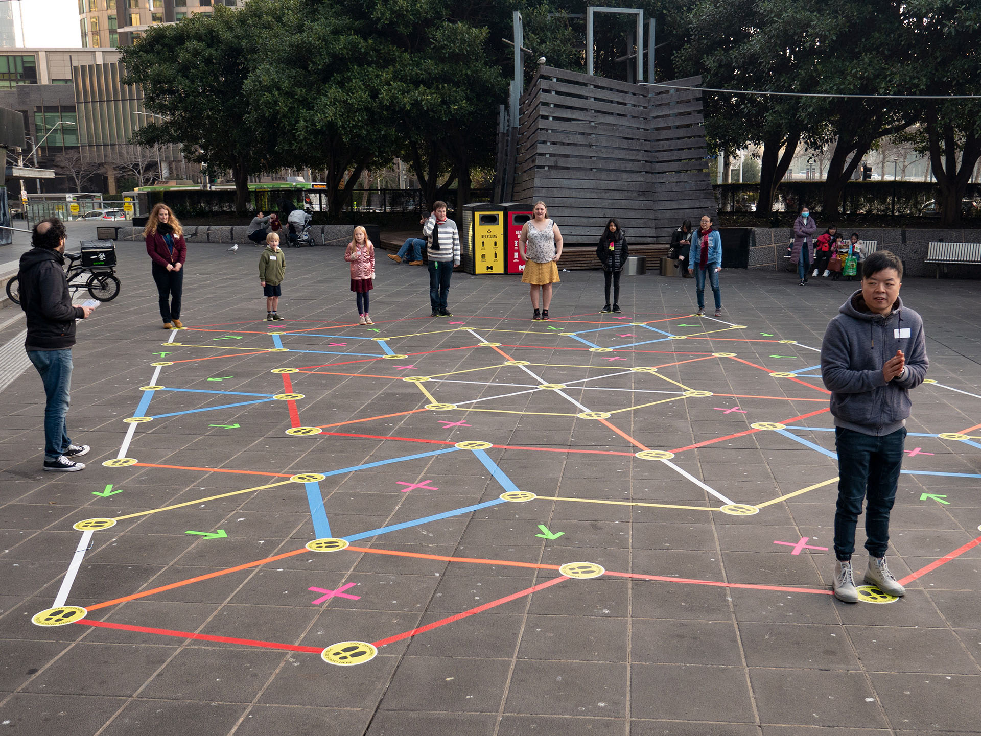 Players standing in a line on the Street Tape Games installation, ready to play a game.