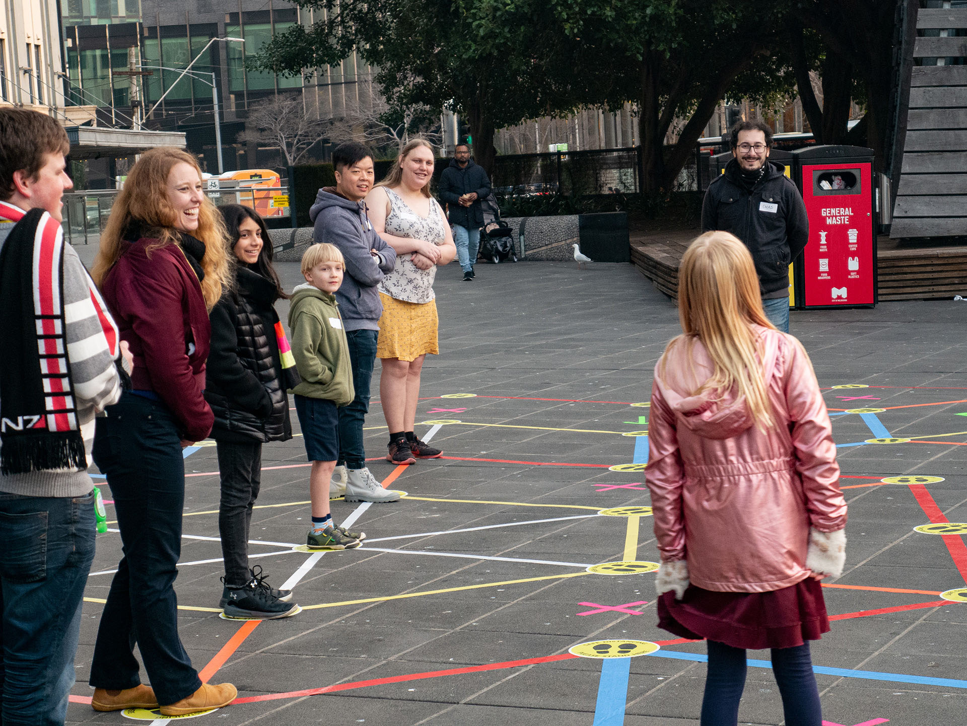 Facilitator engaging with a player on the Street Tape Games installation.