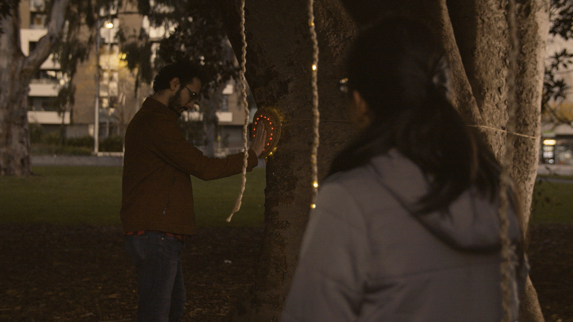 One player touching Heartree's trunk sensor and another touching a rope.