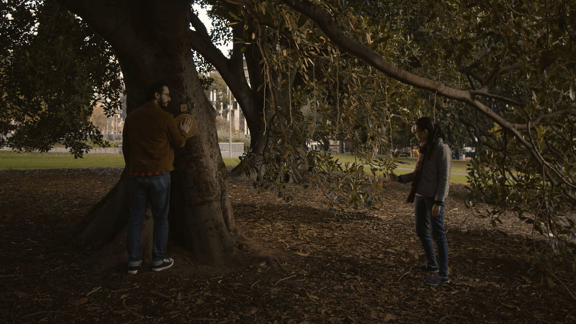 One player touching Heartree's trunk sensor and another touching a rope.