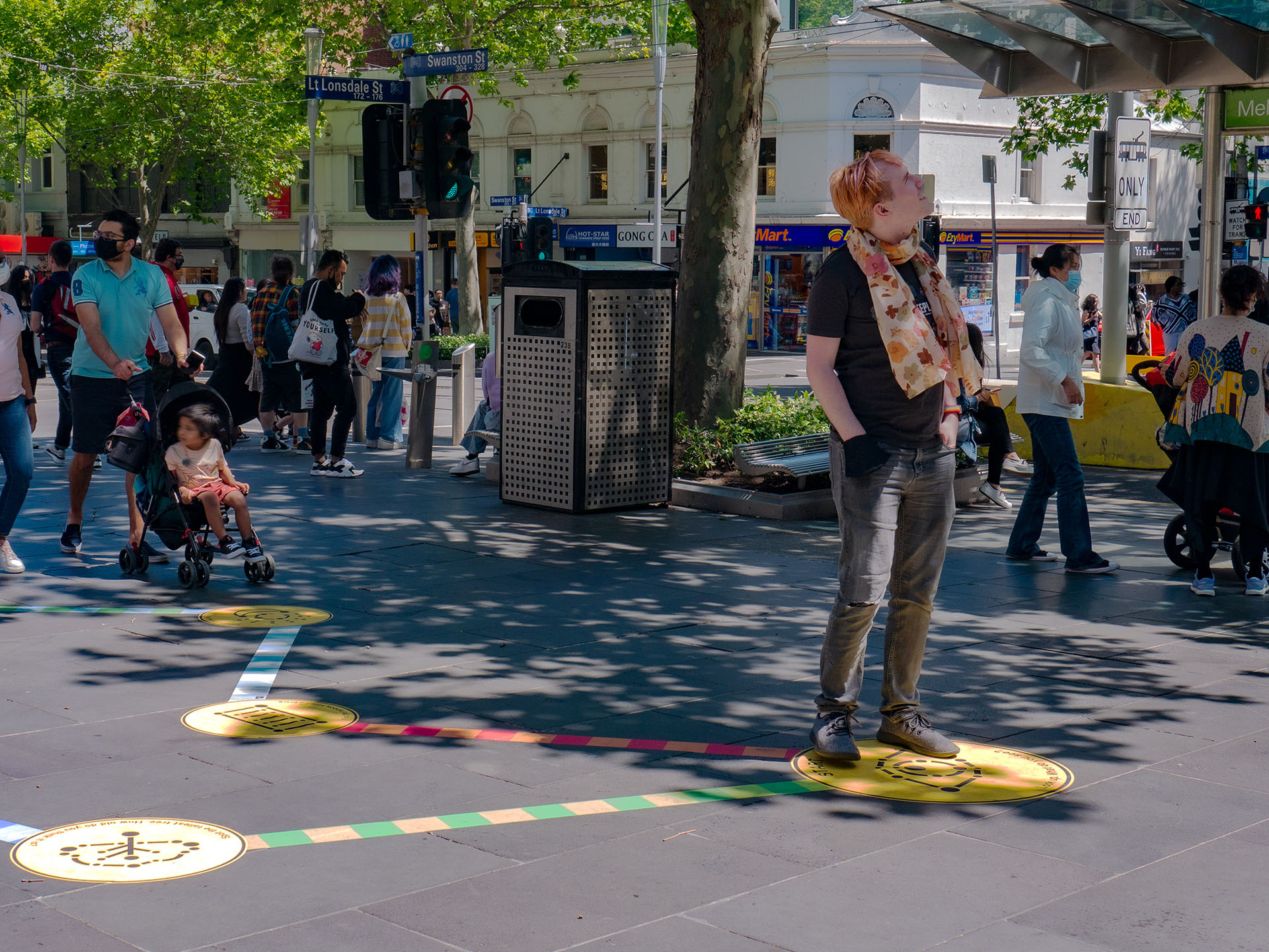 A player looking up playing a mini-game part of the Rainbow Paths installation at SLV.