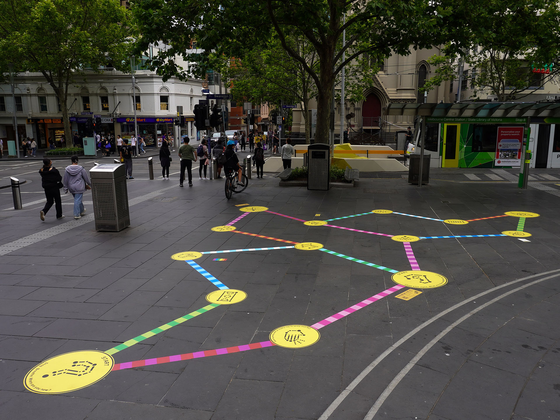 Wide shot of the Rainbow Paths installation at SLV, overlooking Swanston St.