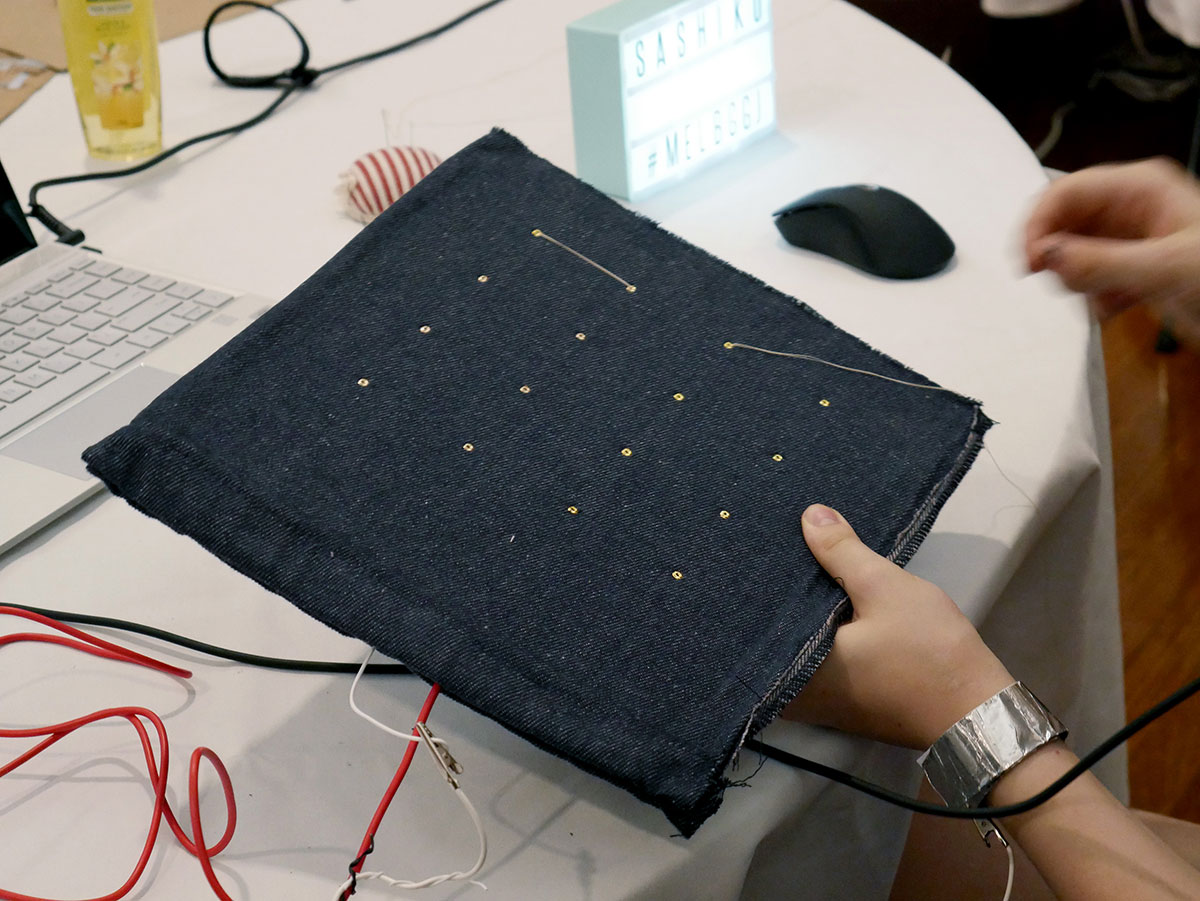 Close-up of someone sewing using the Sashiko controller.
