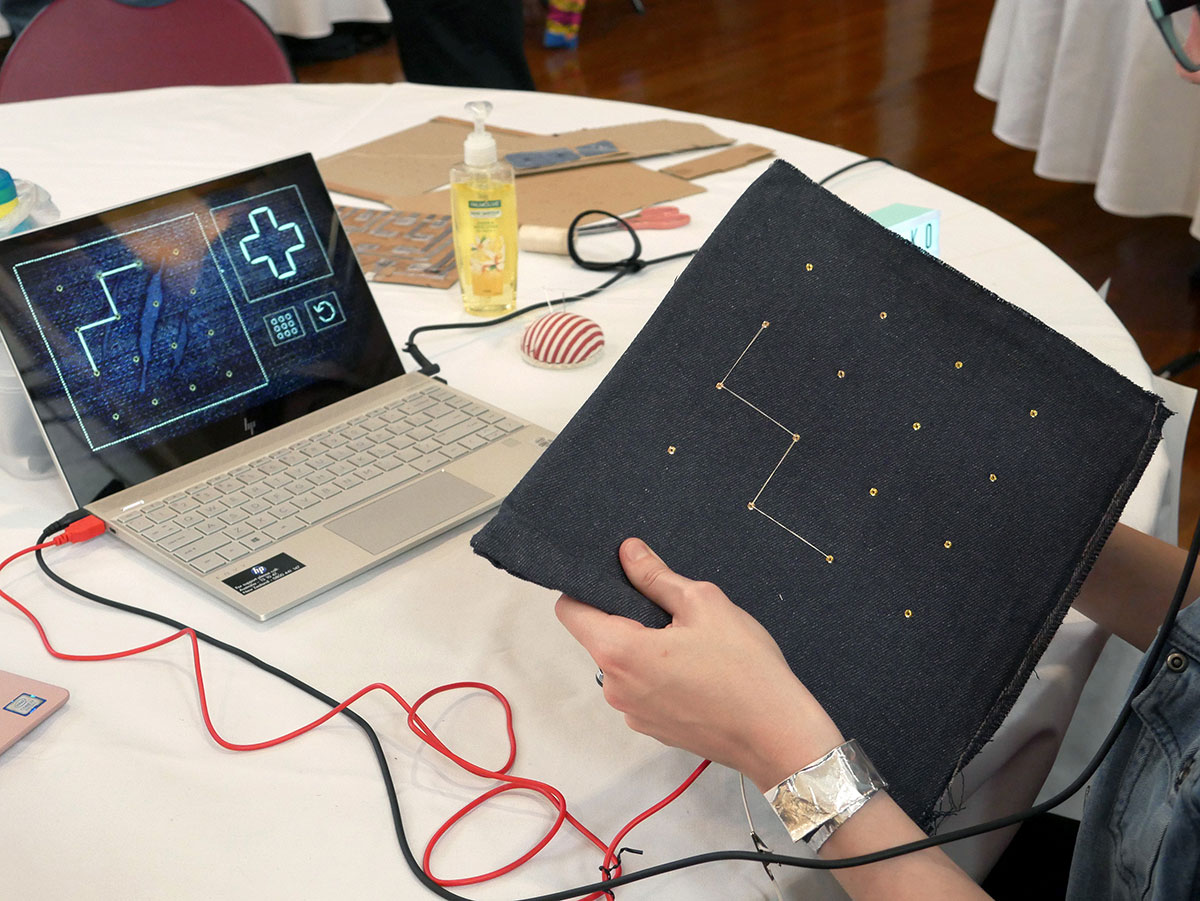 Player following the pattern on the Sashiko screen and sewing on the Sashiko controller.