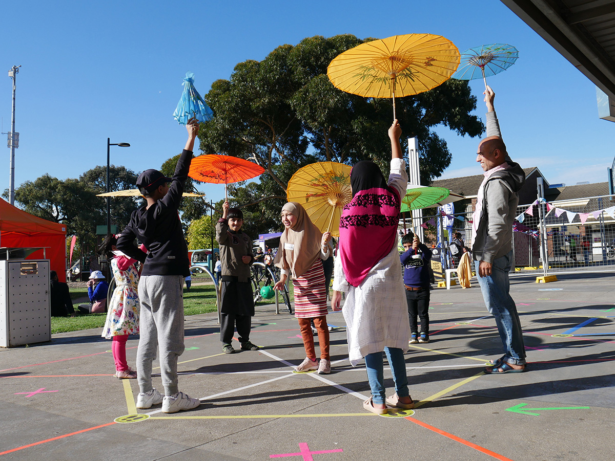 A group of players holding their umbrellas in the air during a game.