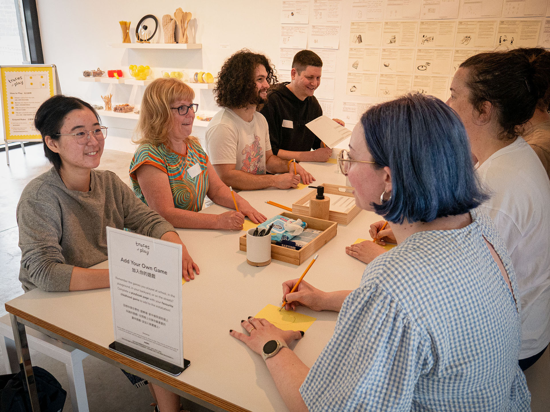 Participants facing and drawing each other during the Traces of Play workshop.
